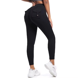 May include: Black leggings with a high waist and two small pockets on the back. The leggings are form-fitting and made of a smooth, opaque fabric. The model is wearing white sneakers.