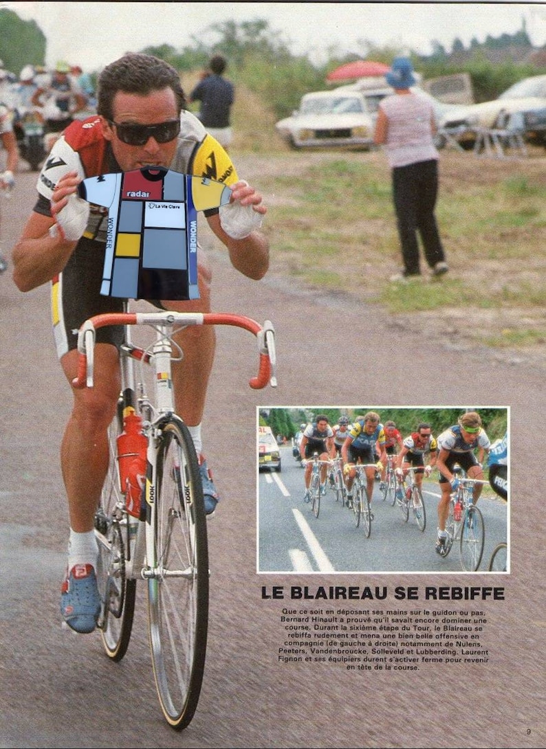 May include: A cyclist wearing a blue, yellow, and white cycling jersey with the word "WONDER" on the sleeves. The cyclist is riding a bicycle with red handlebars and a white frame. The text "LE BLAIREAU SE REBIFFE" is visible in the lower right corner of the image.
