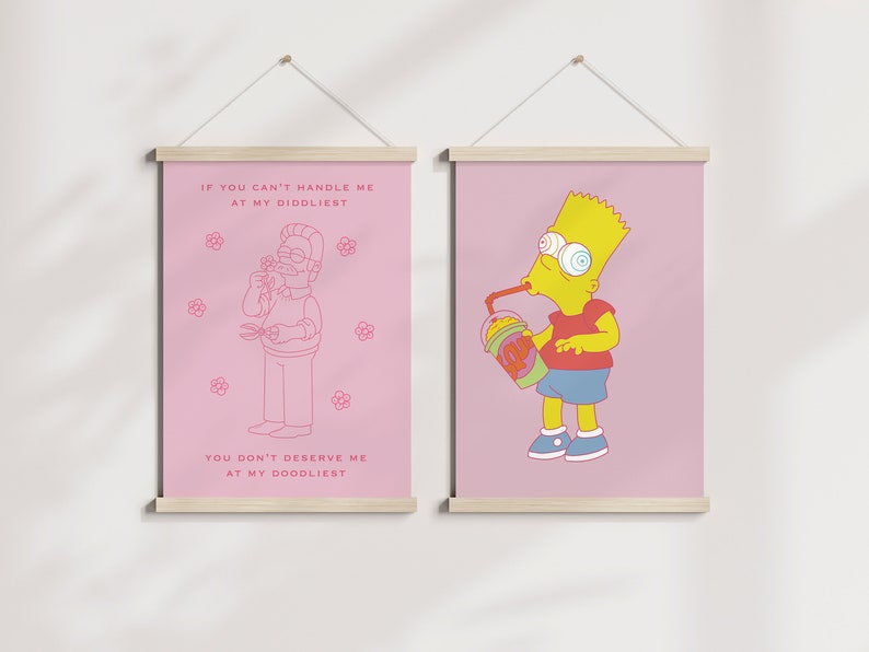 May include: Two pink framed prints with white text and cartoon illustrations. The left print features a cartoon man with a beard and the text "If you can't handle me at my diddliest, you don't deserve me at my doodliest". The right print features a cartoon yellow character with blue eyes and the text "If you can't handle me at my diddliest, you don't deserve me at my doodliest".
