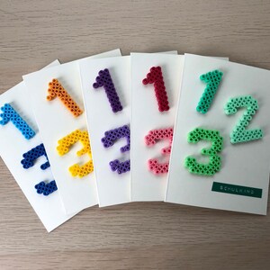 Karte zur Einschulung/Schulbeginn aus Bügelperlen in verschiedenen Farben