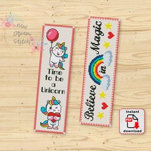 May include: Two cross-stitch bookmark patterns featuring unicorns. The first bookmark features a unicorn holding a heart and the text "Time to be a Unicorn". The second bookmark features a rainbow and the text "Believe in Magic".
