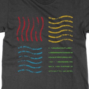 May include: Dark grey t-shirt with a distressed graphic of four elemental symbols: red wavy lines, yellow wavy lines, blue wavy lines, and green horizontal lines. The design is centered on the front of the shirt.