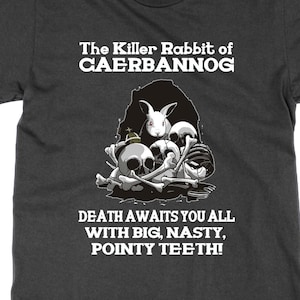 May include: Dark gray t-shirt with the text "The Killer Rabbit of CAERBANNOG" and "DEATH AWAITS YOU ALL WITH BIG, NASTY, POINTY TEETH!". The graphic features a rabbit, skulls, and bones. A humorous and dark design.