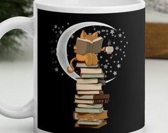May include: White ceramic mug with a black design of a cat sitting on a stack of books with a cup of coffee in its paw. The cat is reading a book and sitting on a crescent moon with stars in the background.