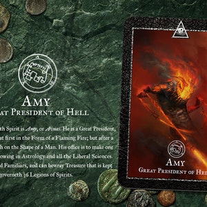 May include: A black and red card with a white border and a gold seal. The card features an illustration of a fiery demon with chains. The text on the card reads "AMY GREAT PRESIDENT OF HELL".