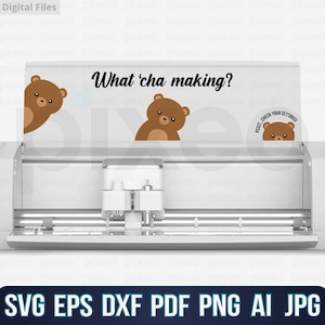 May include: A white silhouette cutting machine with a brown bear peeking over the top. The machine has a silver cutting blade and a black text overlay that reads "What 'cha making?"