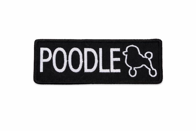 May include: Black rectangular patch featuring the word "POODLE" in white capital letters and a white poodle silhouette. Suitable for application on clothing or accessories.