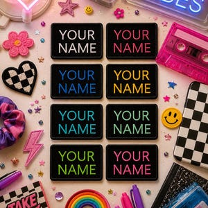 May include: A collection of colorful patches, stickers, and accessories. Includes patches with "YOUR NAME" embroidered in various colors, a neon "GOOD VIBES" sign, a rainbow, and a cassette tape. Other items include a smiley face patch and a notebook.
