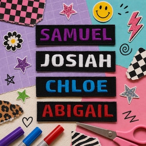 May include: Four black name patches with embroidered names: SAMUEL in purple, JOSIAH in white, CHLOE in blue, and ABIGAIL in red. The patches are surrounded by decorative elements like stars, a smiley face, and scissors, on a colorful background.