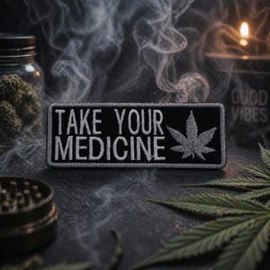 May include: A black patch with the text "TAKE YOUR MEDICINE" in white, along with a white cannabis leaf. The patch is set against a dark background with smoke, a jar, and a candle.