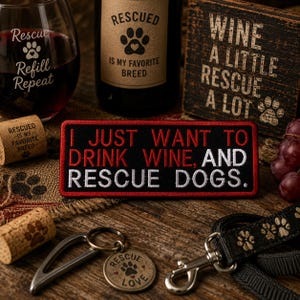 May include: A collection of items with a wine and dog rescue theme. Features a wine glass with "Rescue Refill Repeat", a wine bottle with "Rescued is my favourite breed", and a sign saying "Wine a little rescue a lot". Also includes a patch that says "I just want to drink wine, and rescue dogs."