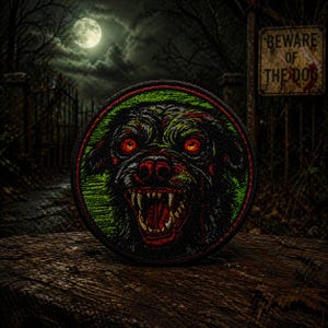 May include: Round patch featuring a snarling dog with red eyes and sharp teeth. The dog is black and green, with a red mouth. The patch has a green and red border. The background shows a full moon, trees, and a sign that says "Beware of the Dog."