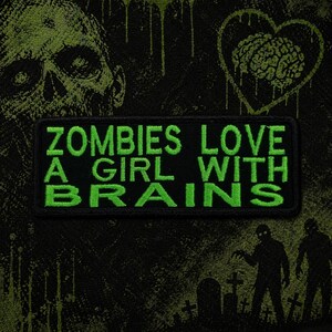 May include: Black patch with green embroidered text that reads "ZOMBIES LOVE A GIRL WITH BRAINS." The background features a green zombie skull, a heart with a brain, and zombie silhouettes. The patch is rectangular.
