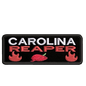 May include: Black rectangular patch with white text that reads "CAROLINA REAPER" and two red flames on either side of the text. A red chili pepper is centered below the text.