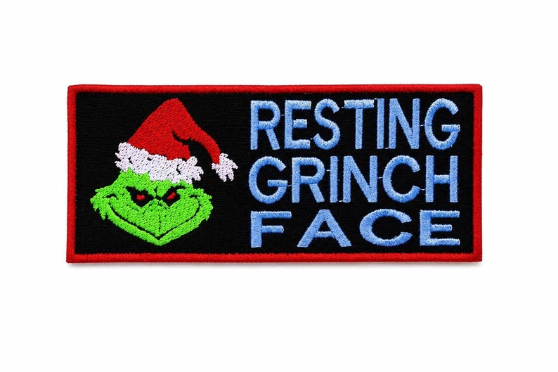 May include: Embroidered patch with a black background and a red border. The patch features a green Grinch wearing a Santa hat and the words "RESTING GRINCH FACE" in blue.