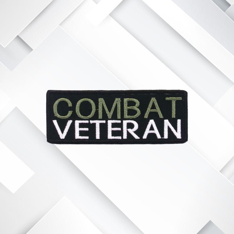 May include: Black embroidered patch with the text "COMBAT VETERAN" in white and green lettering.