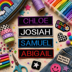 May include: An assortment of colorful patches and craft supplies are arranged on a light-colored surface. Four rectangular patches display embroidered names: CHLOE, JOSIAH, SAMUEL, and ABIGAIL. Other patches include a rainbow, smiley face, and a checkered heart.