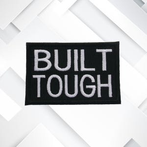 May include: Black embroidered patch with white text that reads "BUILT TOUGH".