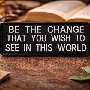 May include: A set of three ceramic mugs with a speckled, matte finish. The mugs are in shades of cream, light grey, and dark grey. Each mug has a simple, minimalist design, ideal for coffee or tea.