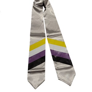 May include: A silver graduation stole with a diagonal stripe pattern in yellow, white, purple, and black.