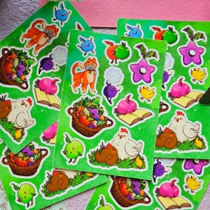 May include: A set of 10 green and white sticker sheets featuring various illustrations of animals, food, and other whimsical designs. The stickers are perfect for adding a touch of personality to journals, laptops, water bottles, and more.
