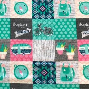 May include: A colorful fabric with a patchwork design featuring various images, including a compass, a bicycle, a camper van, a backpack, and a cactus. The fabric also includes the text "Happiness is a Journey".