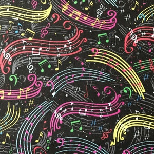 May include: A black fabric with a colorful musical note pattern. The notes are in various colors, including pink, blue, green, yellow, and white. The notes are arranged in a random pattern on the fabric.
