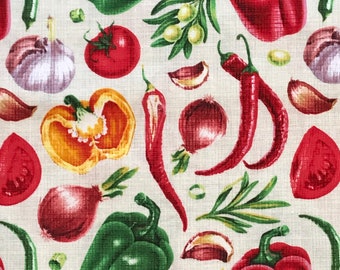 May include: A colorful fabric with a repeating pattern of various vegetables, including red peppers, green peppers, red onions, garlic, tomatoes, and chili peppers. The background is a light cream color.