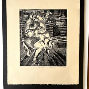 May include: A black and white woodcut print on cream paper featuring a seated figure with arms crossed, surrounded by stylized birds and geometric patterns. The artwork is signed and titled Pacita Santomaso 841 at the bottom, framed in a black mat.