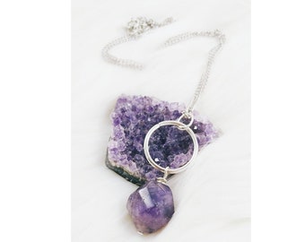 A simple purple stone and circle necklace.