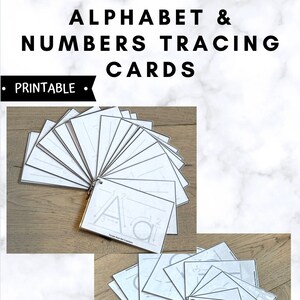 May include: A set of printable alphabet and number tracing cards. The cards are white with black lines for tracing letters and numbers. The cards are arranged in a fan shape on a wooden surface. The text "Printable" is visible at the top of the image.