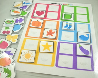 May include: A colorful educational game for kids with the title "Sort by Colour". The game includes a variety of images, such as a heart, a pumpkin, a star, a sun, a leaf, a sock, a whale, and an eggplant. The images are arranged in a grid with different colored borders.