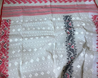 May include: A white and pink patterned textile with a red border. The fabric features floral and geometric designs. The textile has a delicate, lightweight appearance, suggesting it is made of a fine material like cotton or silk.