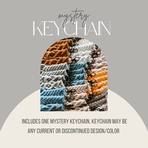 May include: A variety of colorful macrame keychains with black metal clasps. The text "mystery KEYCHAIN" is at the top of the image. The text "INCLUDES ONE MYSTERY KEYCHAIN. KEYCHAIN MAY BE ANY CURRENT OR DISCONTINUED DESIGN/COLOR" is at the bottom of the image.