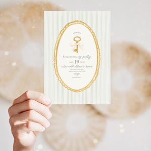 May include: A housewarming party invitation card with a gold key illustration inside a gold oval frame. The card has a light green striped background and includes event details: date, time, location, and RSVP information.