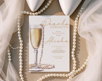 Puede incluir: Una invitación a una despedida de soltera con el texto "Pearls & Prosecco" y "Alisha" en escritura dorada, junto con una ilustración de una copa de champán. La invitación está rodeada por un collar de perlas, zapatos blancos y tela transparente.