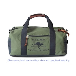 May include: Olive green canvas duffel bag with black canvas side pockets and base, and black webbing. Features a brown leather handle and the text "E.J. LOKE WEATHER PROOF MADE IN AUSTRALIA" with a kangaroo graphic.