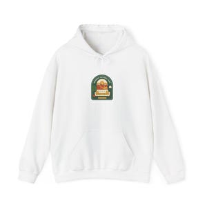 May include: White hooded sweatshirt with a front pocket and a drawstring hood. The sweatshirt features a patch with the text "Dinosaur National Park" and a graphic of a dinosaur and mountains.