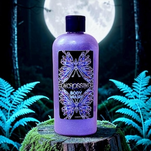 May include: A purple glittery body wash in a clear plastic bottle with a black cap. The rectangular label features two blue and purple butterfly illustrations and the text "UNCROSSING BODY WASH" in a white stylized font against a black background.