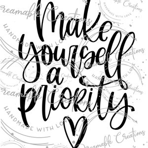 May include: Black and white typography art print with the text "Make yourself a priority" and a heart shape. The print has a white background and is surrounded by a silver circle pattern.