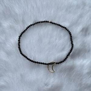 ¡Delicada pulsera de ónix y oro con dije de luna dorada!