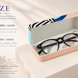 May include: A pair of black-framed eyeglasses rests inside an open, rectangular eyeglasses case. The case is peach-colored with a patterned lid featuring black, white, and blue designs. The text "SIZE" is at the top, with dimensions in centimeters.