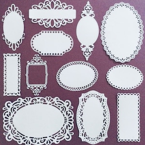 May include: A set of 11 white paper doily-style frames with intricate designs. The frames are perfect for scrapbooking, card making, and other craft projects.