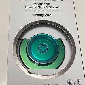 May include: A PopSockets Magnetic Phone Grip & Stand for MagSafe in a white box. The grip is iridescent green and teal. The packaging includes the PopSockets logo and text indicating compatibility with MagSafe chargers.