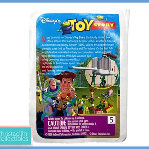 May include: A collectible Disney's Toy Story promotional card. The card features images of Woody, Buzz Lightyear, and other characters from the movie. Text on the card includes the movie title, a brief synopsis, and safety information. The card is numbered 5.