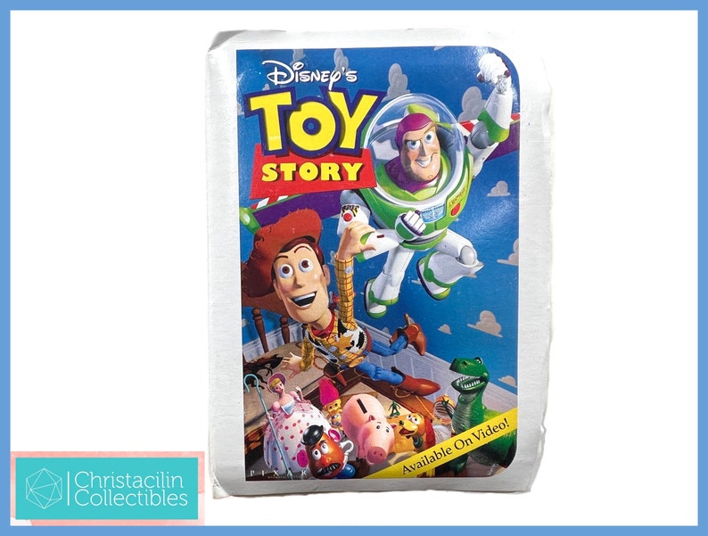 May include: A vintage Disney's Toy Story VHS tape. The cover features Woody, Buzz Lightyear, and other characters against a blue background. The text "Toy Story" is prominently displayed.