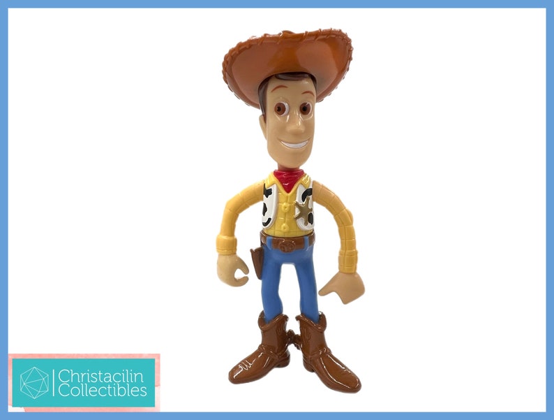 May include: A Woody action figure from the Toy Story franchise. The figure is wearing a brown cowboy hat, a yellow shirt, a red bandana, blue jeans, and brown boots. The figure has a sheriff's badge and a holster.
