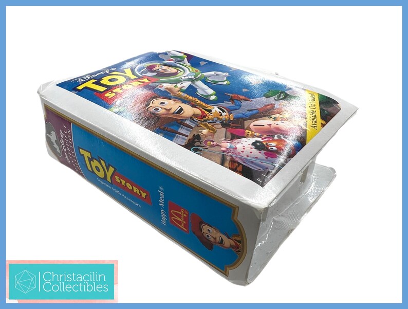 May include: A sealed Disney Toy Story VHS tape from a McDonald's Happy Meal. The tape features a colorful image of Woody, Buzz Lightyear, and other characters from the movie. The packaging is blue and white.