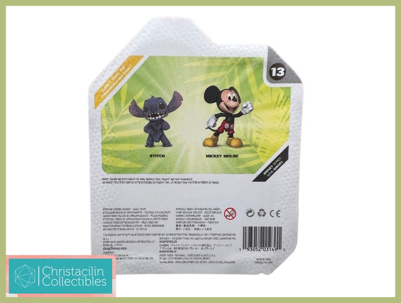 May include: A package featuring two Disney figurines: Stitch and Mickey Mouse. Stitch is a dark blue alien with large ears, and Mickey Mouse is in his classic outfit. The package has a green and white background with the number 13.