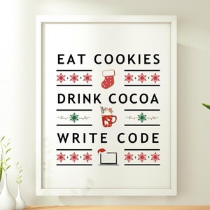May include: White framed print with a Christmas-themed design. The text reads "Eat Cookies, Drink Cocoa, Write Code" with a stocking, a mug of hot cocoa, and a laptop with a Santa hat on the screen.